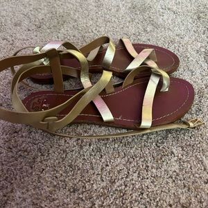Tory Burch Brown sandals with gold straps.